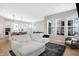 Open-concept living room with a comfortable sofa, large windows, and seamless flow to the kitchen area at 1935 Ponsonby Dr, Westfield, IN 46074