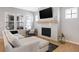 Bright living room with a modern fireplace, plush sofa, and large windows for ample natural light at 1935 Ponsonby Dr, Westfield, IN 46074