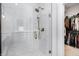 Modern walk-in shower featuring a rainfall shower head and elegant tile design at 1935 Ponsonby Dr, Westfield, IN 46074