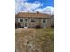 Charming back exterior showcasing well-maintained siding, updated windows and a fenced yard at 2006 Medford Ave, Indianapolis, IN 46222