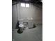 Basement bathroom featuring a toilet and sink, providing added convenience and functionality at 2006 Medford Ave, Indianapolis, IN 46222