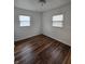 Bright bedroom featuring hardwood floors, fresh white paint, and natural light from the windows at 2006 Medford Ave, Indianapolis, IN 46222