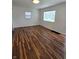 Spacious living room featuring hardwood floors and bright natural light from the windows at 2006 Medford Ave, Indianapolis, IN 46222