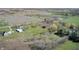 Expansive aerial view of a rural property featuring a home, outbuildings, and large green fields at 2141 E County Road 200 N, Danville, IN 46122