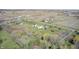 Wide aerial shot of a property featuring a home with outbuildings amid picturesque farmlands at 2141 E County Road 200 N, Danville, IN 46122