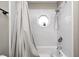 Bathtub with white tile surround and a small octagon window at 2141 E County Road 200 N, Danville, IN 46122