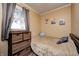 Cozy bedroom with a single bed, wooden storage unit, and a bright window offering natural light at 2141 E County Road 200 N, Danville, IN 46122