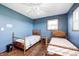 Bedroom with two beds, wood floors, a ceiling fan and a window at 2141 E County Road 200 N, Danville, IN 46122