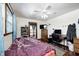 A cozy bedroom with hardwood floors, wood trim, and a ceiling fan at 2141 E County Road 200 N, Danville, IN 46122