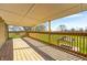 Large, covered wooden deck with natural sunlight and backyard view of trees and grass at 2141 E County Road 200 N, Danville, IN 46122
