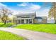 Charming two-story home with a well-manicured front lawn, complemented by mature trees and landscaping at 2141 E County Road 200 N, Danville, IN 46122