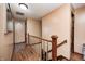 Upstairs hallway with wood railing and wood floors leading to various rooms in the home at 2141 E County Road 200 N, Danville, IN 46122