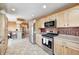 Well-lit kitchen features stainless steel appliances, tiled floors, and an adjacent breakfast nook with bar seating at 2141 E County Road 200 N, Danville, IN 46122