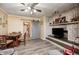 Open concept living space features wood-look floors, a brick fireplace, and access to the dining area at 2141 E County Road 200 N, Danville, IN 46122