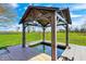 Backyard water feature with gazebo and gold fish pond surrounded by lush green landscaping at 2141 E County Road 200 N, Danville, IN 46122
