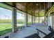 Relaxing front porch featuring a swing and wood plank ceiling, perfect for unwinding at 2141 E County Road 200 N, Danville, IN 46122