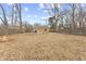 Large, open backyard with patio, fire pit, and a wooden fence at 2253 W Coil St, Indianapolis, IN 46260