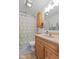 Charming bathroom features a wood vanity, stylish shower curtain, and updated fixtures at 2253 W Coil St, Indianapolis, IN 46260