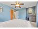Light blue bedroom featuring a ceiling fan, dresser, and ensuite bathroom at 2253 W Coil St, Indianapolis, IN 46260