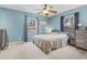 Serene bedroom with ample natural light, a ceiling fan, and calming blue walls at 2253 W Coil St, Indianapolis, IN 46260