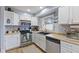 Bright kitchen with white cabinets, stainless steel appliances, neutral countertops, and a window view at 2253 W Coil St, Indianapolis, IN 46260
