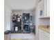 Efficient laundry area with stacked washer/dryer and stainless steel refrigerator at 2253 W Coil St, Indianapolis, IN 46260