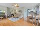 Bright open-plan living room with hardwood floors, ceiling fan, and combined dining area, creating a warm ambiance at 2253 W Coil St, Indianapolis, IN 46260