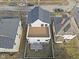 Aerial view of a home's backyard with an elevated deck, yard, and mature trees in a neighborhood setting at 2406 Carrollton Ave, Indianapolis, IN 46205