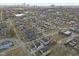 Aerial view of a residential neighborhood with tree-lined streets and a mix of homes and local businesses at 2406 Carrollton Ave, Indianapolis, IN 46205
