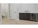 Finished basement features a wet bar with wine fridge and a conveniently located half bathroom at 2406 Carrollton Ave, Indianapolis, IN 46205