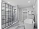 Luxurious bathroom with a freestanding tub, glass-enclosed shower, and elegant marble-look tile at 2406 Carrollton Ave, Indianapolis, IN 46205