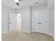 Bright bedroom with light walls, wood-look floors, ceiling fan, and closet with double doors at 2406 Carrollton Ave, Indianapolis, IN 46205
