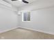 Bright bedroom with light walls, wood-look floors, ceiling fan, and window at 2406 Carrollton Ave, Indianapolis, IN 46205