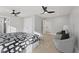 Spacious bedroom with hardwood floors, ceiling fan and neutral decor features dual closets at 2406 Carrollton Ave, Indianapolis, IN 46205