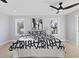 Bright bedroom features a decorative ceiling fan and natural light from the dual windows at 2406 Carrollton Ave, Indianapolis, IN 46205