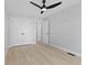 Bright bedroom with hardwood floors, a modern ceiling fan, and closet with double doors at 2406 Carrollton Ave, Indianapolis, IN 46205