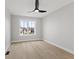 Bright bedroom with hardwood floors, a modern ceiling fan, and a large window at 2406 Carrollton Ave, Indianapolis, IN 46205