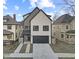 Modern two-story home featuring a two-car garage and concrete driveway at 2406 Carrollton Ave, Indianapolis, IN 46205