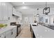 Bright kitchen features white cabinetry, stainless steel appliances, a large island, and modern pendant lighting at 2406 Carrollton Ave, Indianapolis, IN 46205