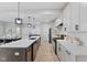 Contemporary kitchen with a long island, white cabinets, and stainless steel appliances at 2406 Carrollton Ave, Indianapolis, IN 46205