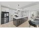 Modern kitchen features a central island, white countertops, and stainless steel appliances at 2406 Carrollton Ave, Indianapolis, IN 46205