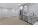 Modern kitchen features stainless steel appliances, white cabinets, subway tile backsplash, and light wood-look flooring at 2406 Carrollton Ave, Indianapolis, IN 46205