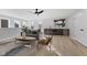Open-concept living room featuring a modern sofa, hardwood floors, and a wet bar at 2406 Carrollton Ave, Indianapolis, IN 46205