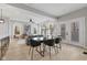 Open-concept living room with hardwood floors, modern décor, and a dining area set for four at 2406 Carrollton Ave, Indianapolis, IN 46205