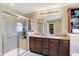 Bright bathroom features double sinks, stylish vanity, tiled glass shower, and updated fixtures at 2504 Boylston Ct, Zionsville, IN 46077