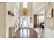 Bright and airy home foyer with high ceilings, hardwood floors, and views into the dining room at 2504 Boylston Ct, Zionsville, IN 46077