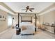 Spacious bedroom featuring a four-poster bed, neutral tones, and stylish accent furniture at 2504 Boylston Ct, Zionsville, IN 46077