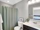 Bathroom features a shower with curtain, matching gray paint, and a mirror at 3046 W New York St, Indianapolis, IN 46222