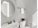Half-bath with pedestal sink, modern fixtures, and natural light at 3046 W New York St, Indianapolis, IN 46222