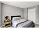 Cozy bedroom with gray walls, a decorative throw pillow, and a matching throw blanket at 3046 W New York St, Indianapolis, IN 46222
